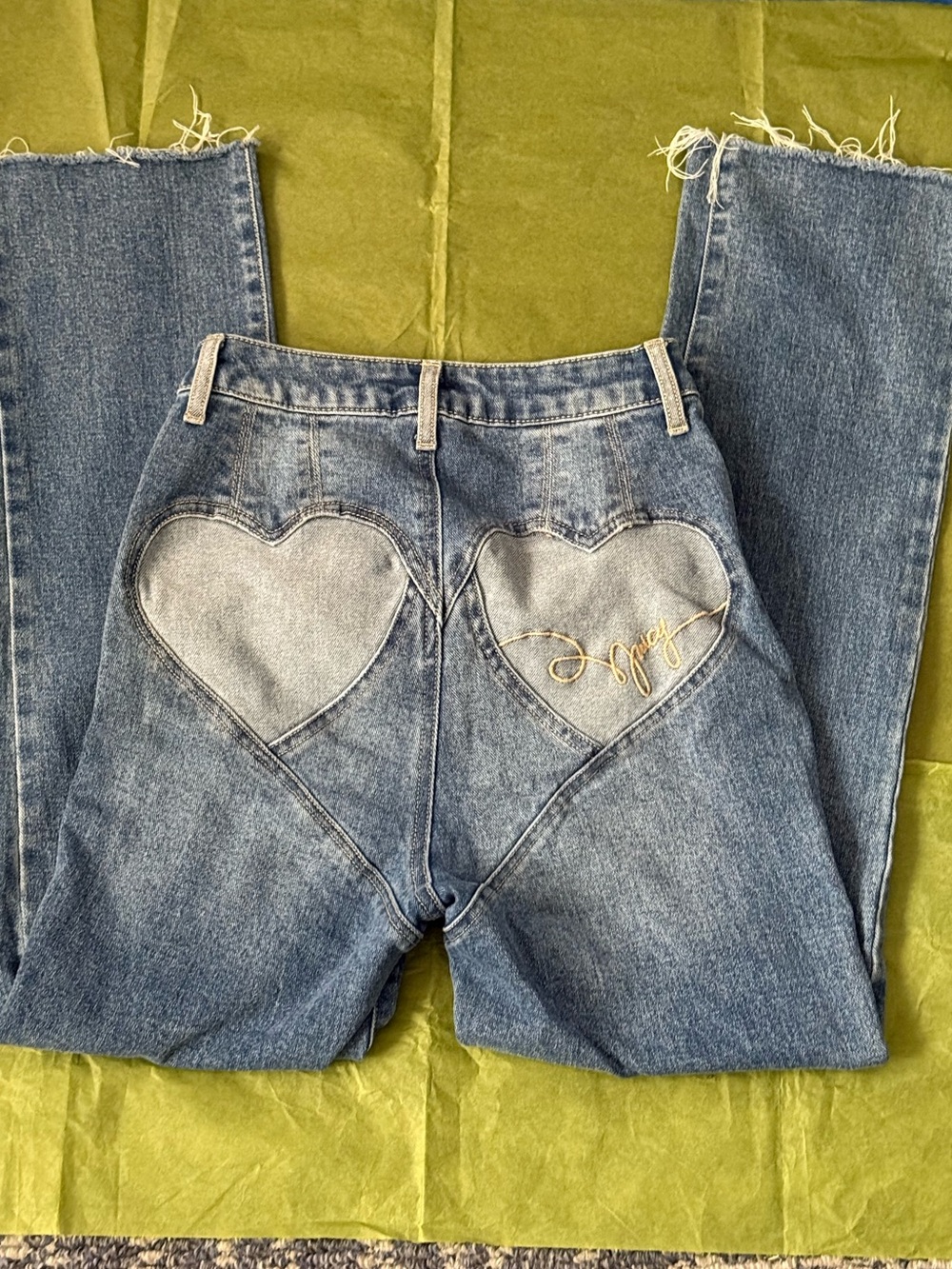 Juicy Couture Blue denim jeans with heart-shaped patches on the back pockets